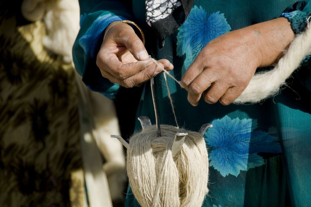 Traditional drop spinning handspinning method for the treasured art of handknotted heirloom Persian carpet weaving in wool