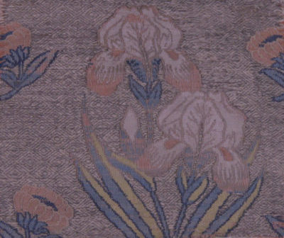 A detailed image of this silk iris textile reveals the ground weft’s neutral diamond design with the lampassed pink, yellow, blue, and white flowers on top of it.