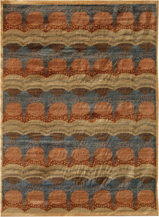 Warm red, pink and blue abstract Persian carpet featuring a circular interior pattern, measuring 9' x 12.' Hand knotted in organic wool.