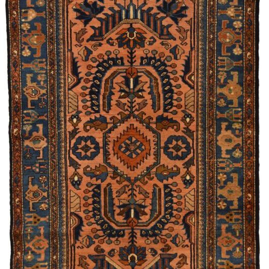  Our antique runner is a perfect example that showcases the similarities and craftmanship in Hamadan carpets. This hand-knotted Hamadan carpet measures 3’3” x 6’5,” and is hand-knotted in warm shades of pink, indigo blue, orange, forest green, and cream wool. Inspired by a traditional Persian flower garden, the design showcases Herati medallion with additional geometric paisley, birds, butterflies, branches, and vine motifs that adorn the field and border. Three details regarding this carpet are especially noteworthy. First, it incorporates multiple traditional Persian textile elements. These include the floral medallion, tree of life design, and circle of life theme among its flora, bird, and butterfly motifs. Second, the pattern is more geometric than most Hamadan designs, which typically depict more curvilinear motifs. Lastly, what truly makes this carpet so unique is the presence of small crucifixes hidden throughout the field. These motifs signify the location where it was created, Armenia. And the crucifix motifs imply that the weaver was Christan, which gives this carpet a touch of added character. Aside from being over 100 years old and in excellent condition, the addition of these small marks makes this carpet exceptionally rare and unique.  