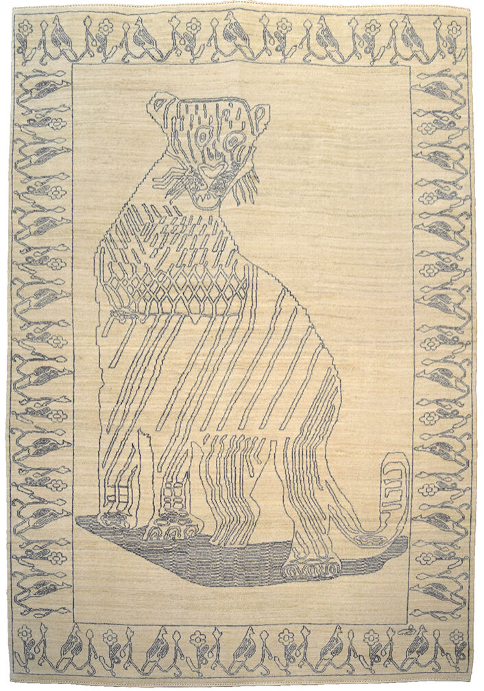 Hand knotted Persian carpet in cream and gray organic wool. Design features a leopard with a border depicting birds and flowers. Carpet measures 6' x 9'.