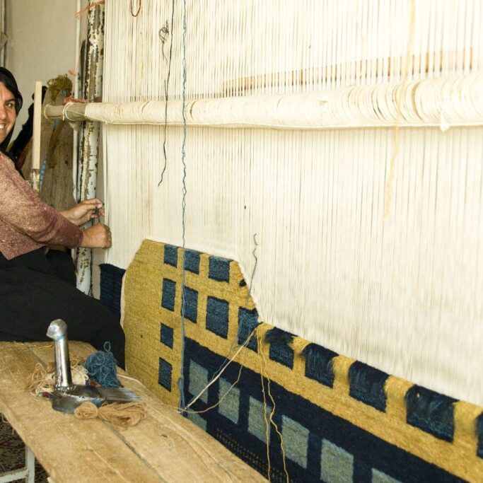 Weaver, located in Iran, weaving a modern, contemporary Persian carpets. 